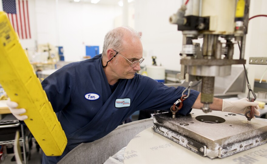 Tom Worden works on a fixed-abrasive grinding table at Exelis Inc. in Rochester, N.Y. Exelis is an aerospace and defense company, and employs numerous former Kodak workers in its facility.