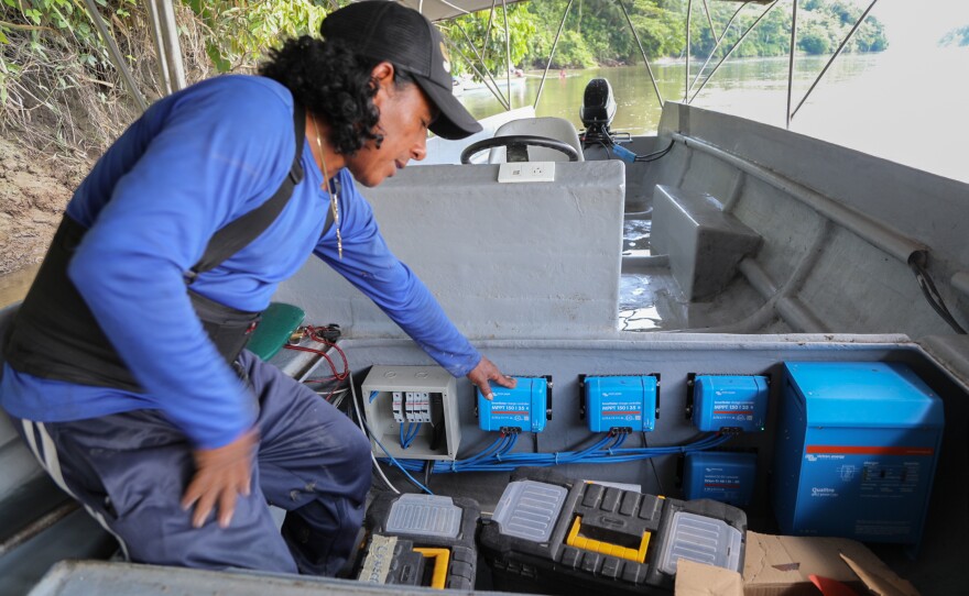 Walter Washikiat, head of a roving team of Indigenous technicians working for Kara Solar, surveys a solar boat.