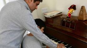 Raj Sodhi helps his son, Jaco, with a piano lesson at the home of a family friend. It’s the fourth place they’ve stayed since the North Bay fires destroyed their home — and Jaco’s school, the Anova Center for Education, Oct. 21, 2017. 