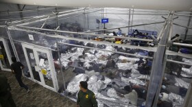 In this March 30, 2021, file photo, minors lie inside a pod at the Donna Department of Homeland Security holding facility, in Donna, Texas. 