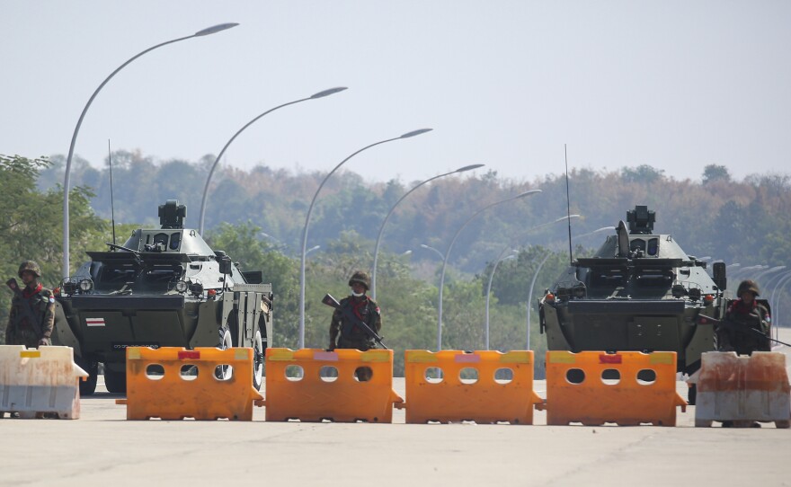 Troops block the road near Parliament in Naypyidaw, capital of Myanmar. Myanmar's military announced Monday that it has seized power and will rule the country for at least one year after detaining its top political leaders.