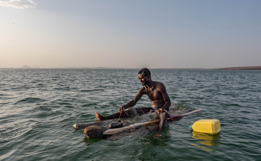 James Lekubo, a 36-year-old El Molo fisherman from Komote Island in lake Turkana,  pulls in his nets while fishing from a traditional raft made of palm trunks. Like others throughout the lake, Lekubo says his catches have dwindled hugely in recent years.