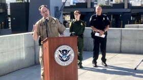 Tim Sutherland, director of Air and Marine Operations for California, speaking at the press conference about the increase in detentions at the U.S.-Mexico border in San Diego on Nov. 1, 2019, as Kathleen Scudder, acting chief Patrol Agent for the San Diego Sector, and Pete Flores, director of field operations for San Diego,
look on.
