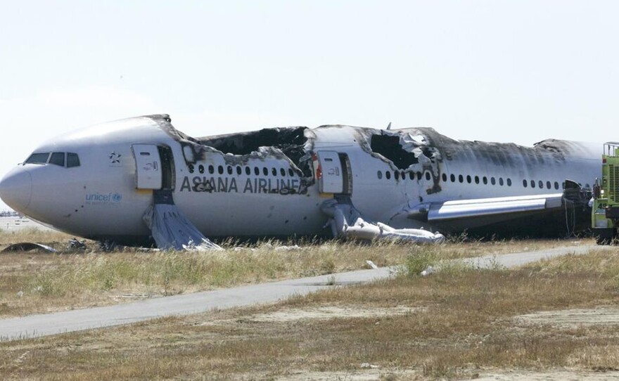 National Transportation Safety Board officials handed out this photo of the burnt shell of Asiana Flight 214 during their first assessment of the crash. Two people died on Saturday and scores more were injured.