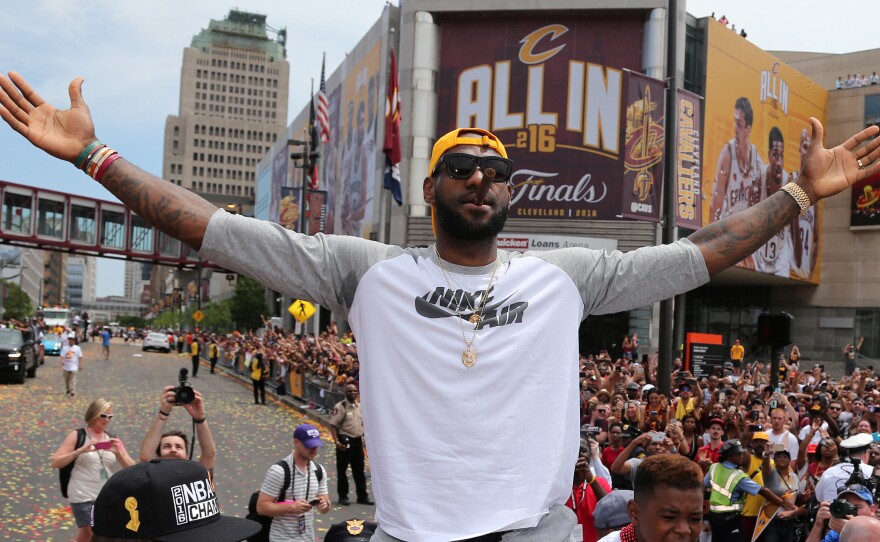 Cleveland Cavaliers forward LeBron James cheers along with the crowd during a parade Wednesday in downtown Cleveland to celebrate the team's 2016 NBA championship.