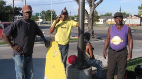 Day laborers Gerard Allen, Dana Matthews, Sammy Davis (seated) and John Pace wait for contractors to hire them at a Lowe's store in New Orleans.
