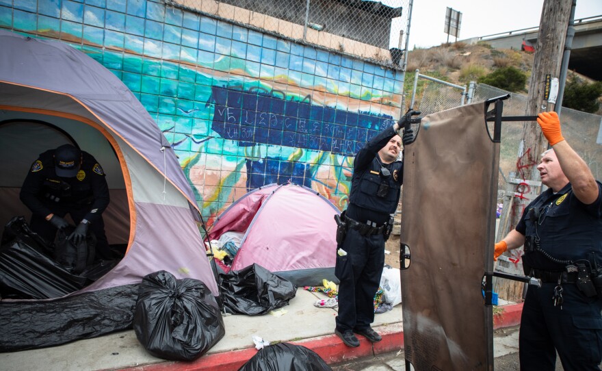 San Diego police impound the belongings of a person who was detained by police for having an outstanding warrant, San Diego, Calif. June 9, 2022.