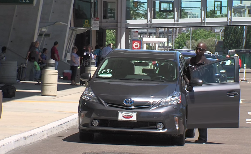 An Uber driver returns to his car at the San Diego International Airport after helping a departing traveller unload his luggage in this undated photo.