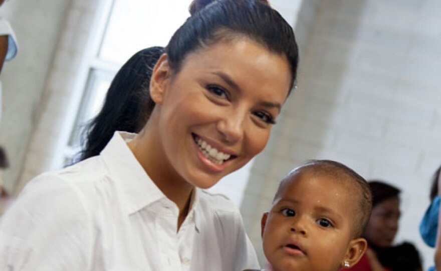 Eva Longoria and a child from Juan Felipe Gómez Escobar Foundation in Cartagena, Colombia.