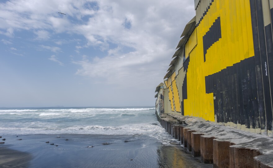 Metal plates atop the new border wall prevent migrants from climbing over, shown on March 14, 2024. Recently, lifeguards on both sides of the border have rescued more migrants trying to swim around the wall.