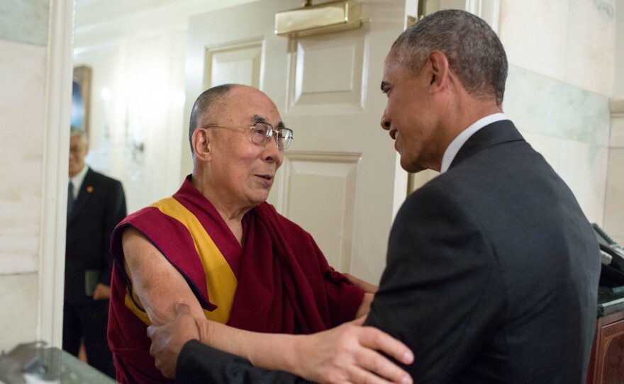 President Obama greets the Dalai Lama at the entrance to the Map Room of the White House Wednesday.
