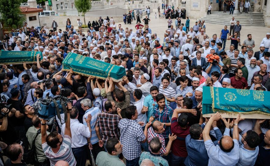 People carry the coffins of Meryem Amiri, Karime Amiri, Zehra Amiri and Huda Amiri during their funerals on Thursday, two days after they were killed by a suicide bombing and gun attack that targeted Istanbul's Ataturk airport.