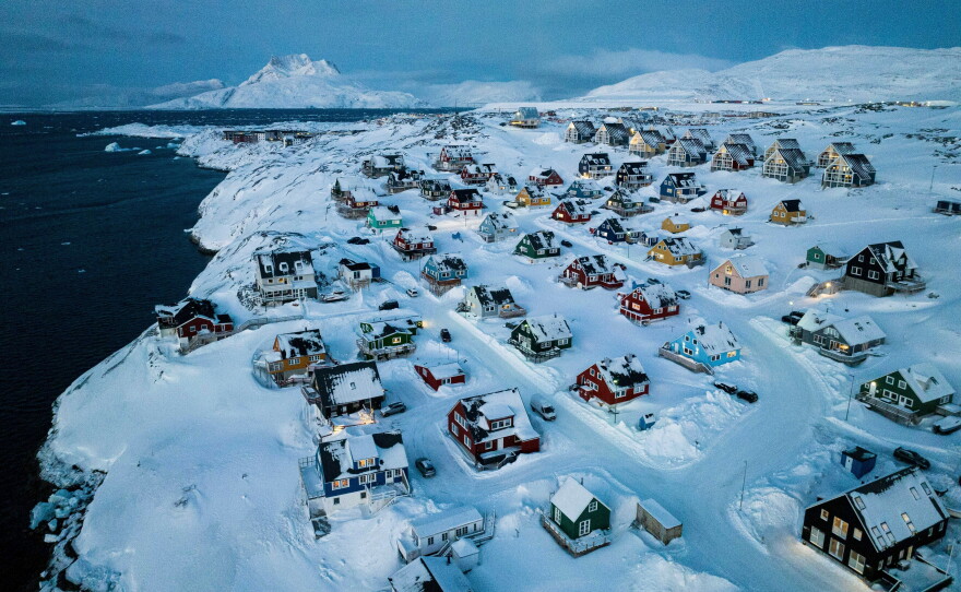 Houses covered in snow are seen on the coast of a sea inlet of Nuuk, Greenland, March 7, 2025.