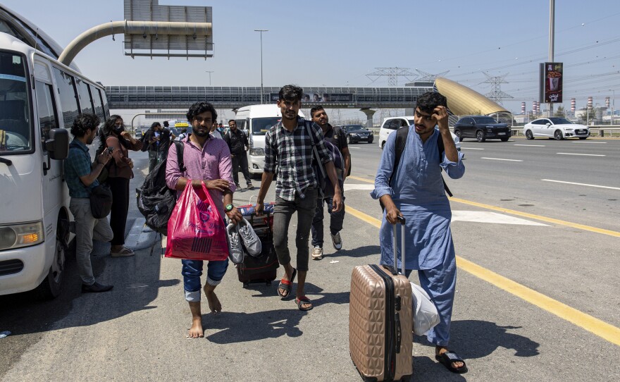People wait for transportation on Sheikh Zayed Road in Dubai on Thursday.