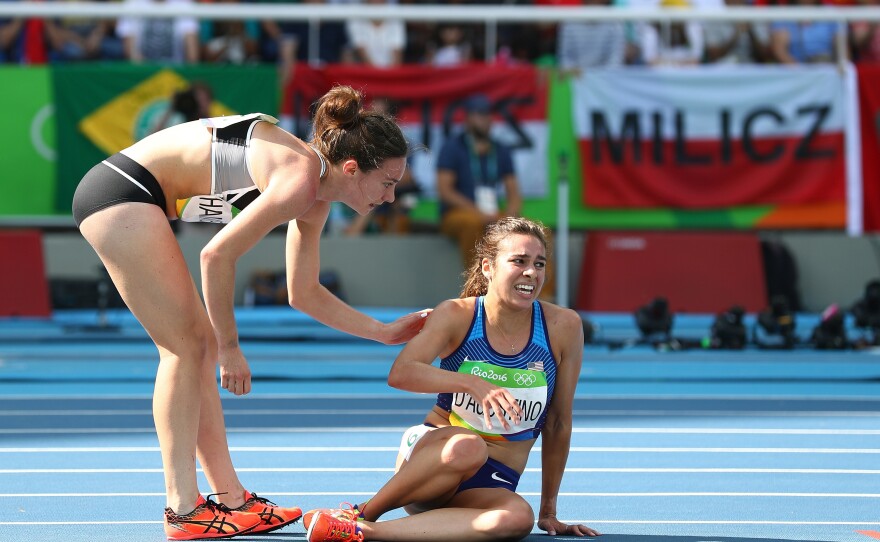 Nikki Hamblin of New Zealand (left) assists Abbey D'Agostino of the United States after a collision during a women's 5,000-meter heat on Tuesday. A moment earlier, D'Agostino had helped Hamblin when they both fell.