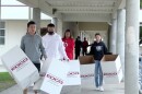 Viliami, Muele, Talia and Siona Thompson carrying boxes to drop off at a donation site at Rancho Buena Vista High School on Jan. 25, 2022.