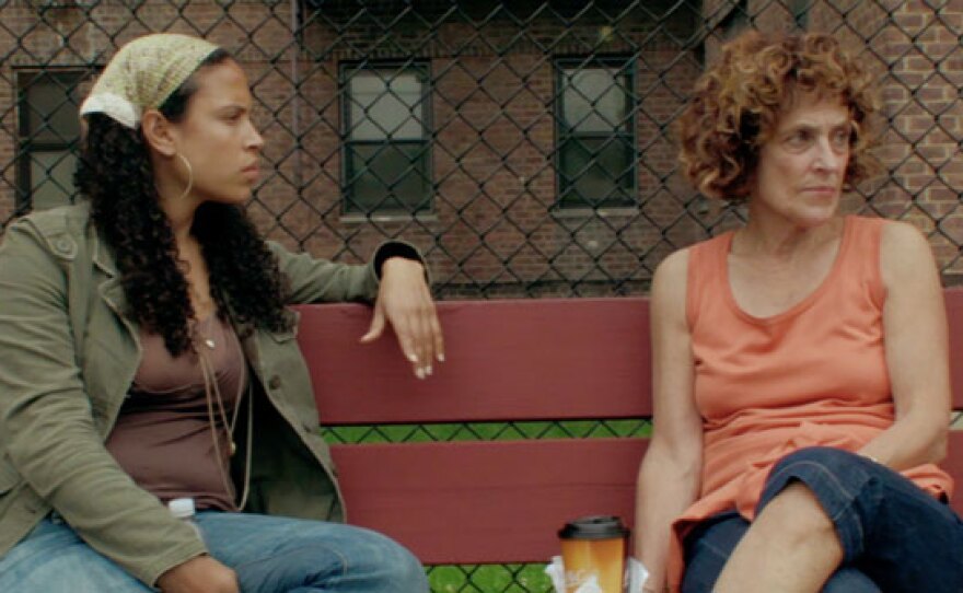 Lacey and her mother sitting on a bench at Foster Park looking tense.