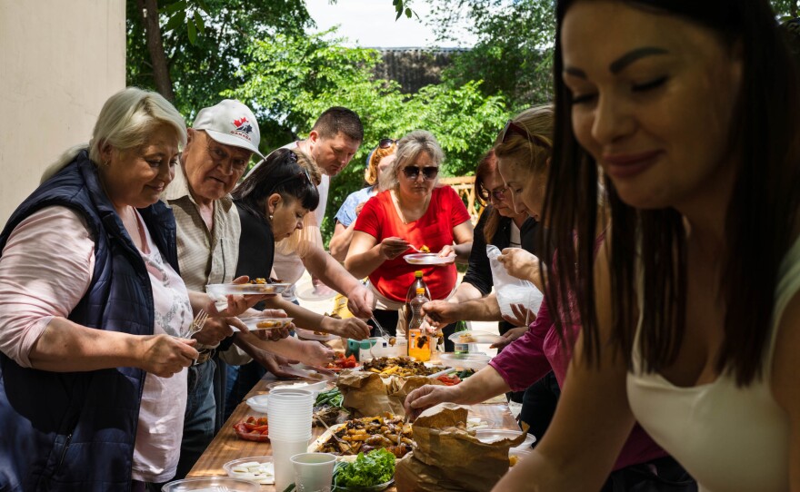 Local volunteers join the mayor (not pictured) of Bilhorod-Dnistrovskyi for an afternoon meal after completing some work, like cleaning up sidewalks and tending to the town's garden beds. Villages in the region are generally small and poor. Soviet monuments still decorate parks. And the area is ethnically varied, with Bulgarian towns, Moldovan, Russian, Ukrainian and others.