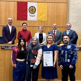 Claudia Rodríguez-Biezunski, founder of Sew Loka, stands in San Diego City Hall with her family and council member Vivian Moreno for the official proclamation of Sew Loka Day in this undated photo.