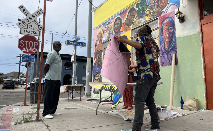 Artists and Elks Lodge members stand in front of a mural at Clementine McDuff Elks Lodge depicting music icons and community figures that have ties to the area, July 28, 2026.