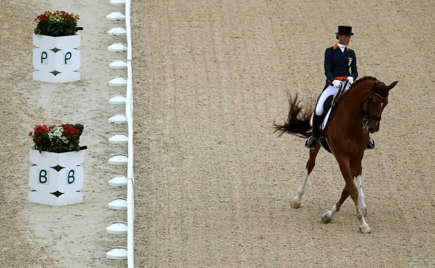 Adelinde Cornelissen of Netherlands and her horse, Parzival, competes in the Dressage Individual Grand Prix event at the Olympic Equestrian Center on Wednesday. Cornelissen dropped out of the competition because her horse was ill.