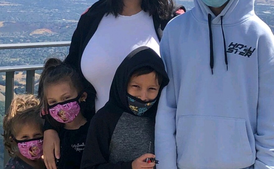 Maria Aguilar poses with her four kids (from left to right: Luna, Athena, Jio and Mauro) while hiking California's Santa Cruz mountains in August 2021. Aguilar and Luna spent four hours in line waiting for a covid-19 test in January.