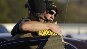 Two Placer County sheriff's deputies embrace after a suspect was arrested in Auburn in connection with the killing of two deputies — one from Sacramento County, the other from Placer County. Oct. 24, 2014. 