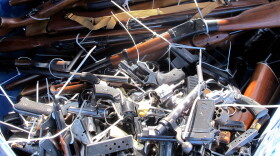 Guns are piled inside a crate outside a police station in Tucson, Ariz., on Tuesday during a buyback. Tuesday marked the second anniversary of when a gunman opened fire on former Rep. Gabrielle Giffords as she met with constituents in 2011, killing six people and leaving 12 others injured.