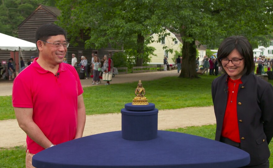 Michelle Cheng (right) appraises an 18th C. Sino-Tibetan gilt bronze bodhisattva, in Sturbridge, Mass. ANTIQUES ROADSHOW “Old Sturbridge Village, Hour 3” premieres Monday, February 12 at 8/7C PM on PBS.