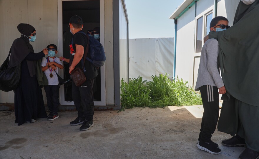 Members of Australian families at Roj Camp in eastern Syria, housing people with alleged ties to Islamic State militants, prepare to leave for Damascus as part of a second repatriation effort by Syrian authorities, Friday, April 24, 2026.