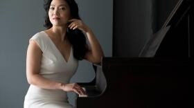 Classical pianist Jeeyoon Kim sitting by a piano in an undated photo. 
