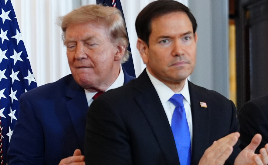 President Donald Trump walks past Secretary of State Marco Rubio as he arrives for a roundtable on the American mining industry, Friday, Aug. 7, 2026, at the State Department in Washington.
