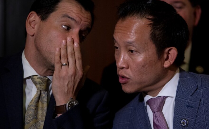 Assembly Speaker Anthony Rendon, left, whispers to then-Assemblymember David Chiu on Sept. 11, 2019.