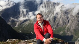 Award-winning TV host and cookbook author Andreas Viestad sits comfortably on top of the mountain, Norway. 