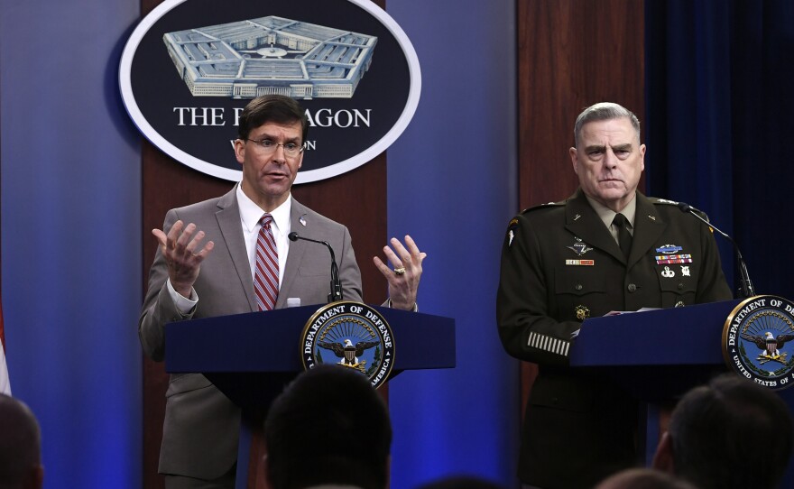 Defense Secretary Mark Esper (left) speaks as Chairman of the Joint Chiefs of Staff Army Gen. Mark Milley listens during a briefing at the Pentagon on Monday.