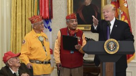 President Donald Trump, right, speaks during a meeting with Navajo Code Talkers including Fleming Begaye Sr., seated left, Thomas Begay, second from left, and Peter MacDonald, second from right, in the Oval Office of the White House in Washington, Monday, Nov. 27, 2017.
