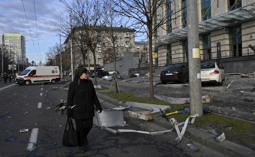 Kyiv: A woman walks past a damaged business centre after a rocket attack.