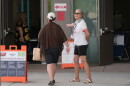 A poll worker assists an Arizona voter at a polling location in Phoenix as people cast their ballots on Tuesday.