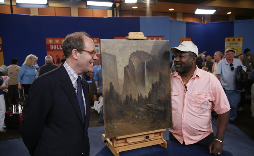 Alan Fausel (right) appraises a 1908 Thomas Virgil Hill painting, in Palm Springs, Calif. 