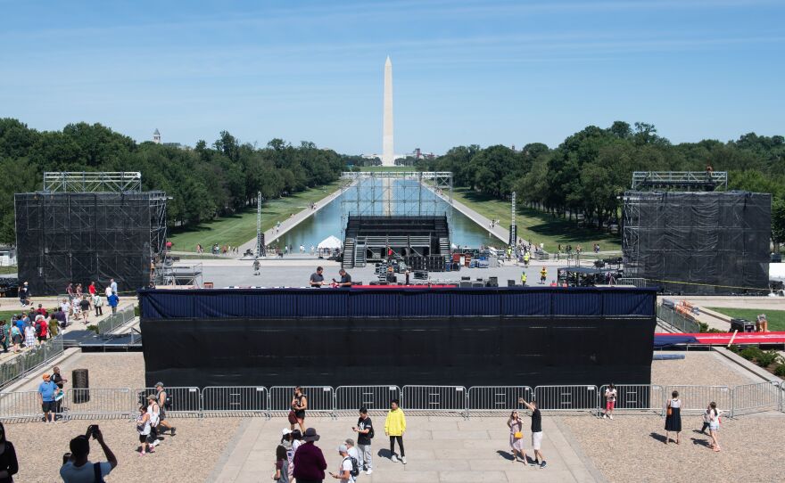 Workers build a stage and bleachers Monday for the "Salute to America" Fourth of July event with President Trump at the Lincoln Memorial on the National Mall.