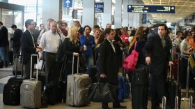  American Airlines passengers wait in line at O'Hare Airport in Chicago, Illinois.
