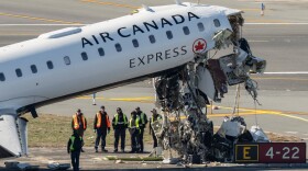 Aircraft maintenance workers inspect the wreckage of an Air Canada Express jet, Tuesday, March 24, 2026, just off the runway where it collided with a Port Authority fire truck Sunday night at LaGuardia Airport in New York.