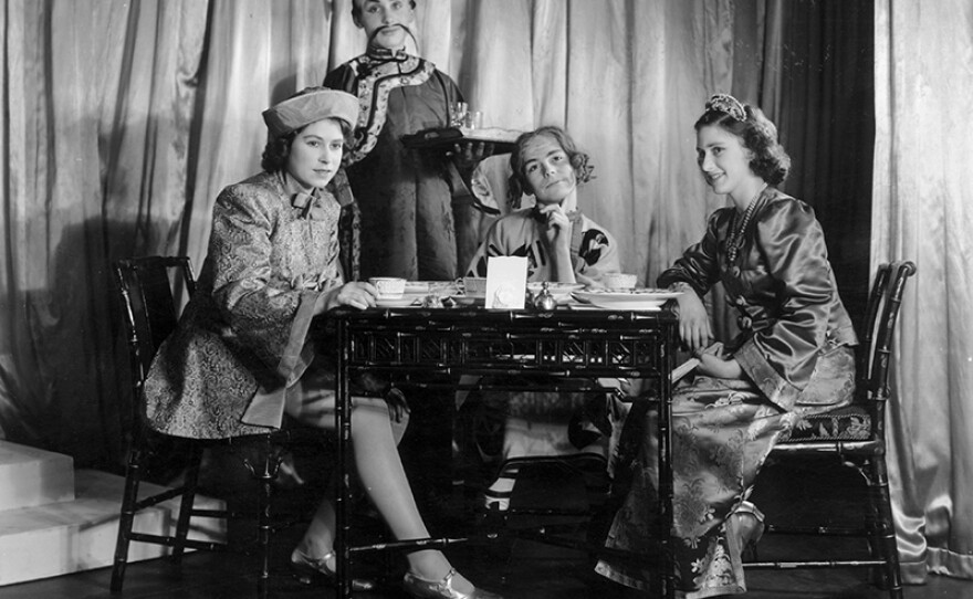 Dec. 6, 1943: Queen Elizabeth II (as Princess Elizabeth), Princess Margaret (1930 - 2002) (right) and two other cast members performing the tea party scene in a production of "Aladdin" at Windsor Castle, Berkshire.