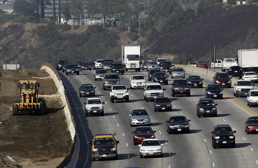 This file photo from October 2010 shows CalTrans, left, working along the 405 Freeway in Los Angeles.