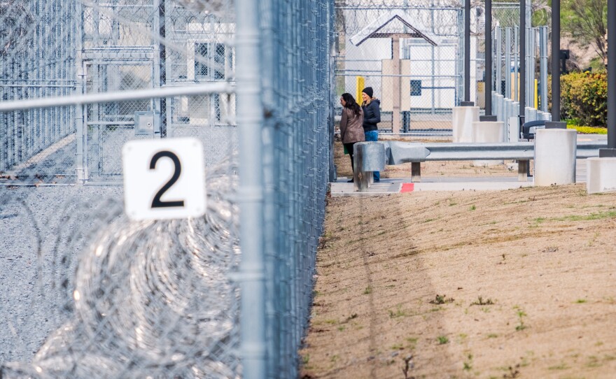 County Supervisors Terra Lawson-Remer and Paloma Aguirre speak through the fence after being denied for a pre-approved inspection at the CoreCivic Detention facility in Otay Mesa, Feb. 20, 2026.