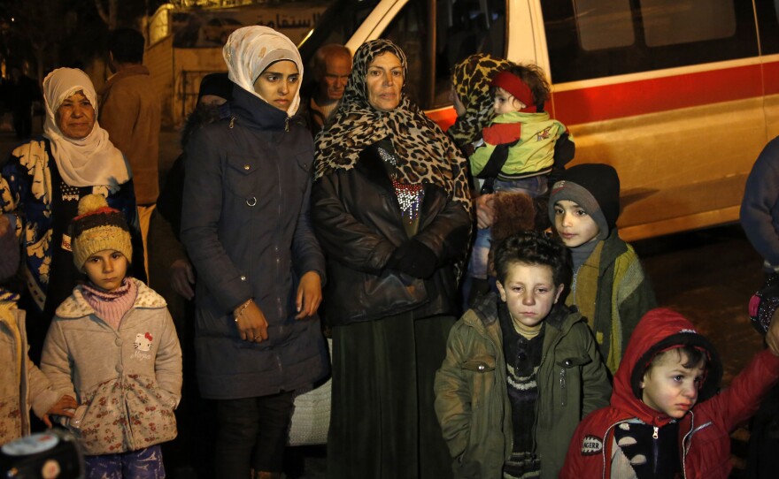 People wait to leave the besieged town of Madaya, northwest of Damascus, Syria, on Jan. 11.