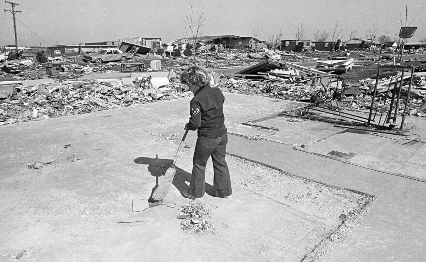 In 1974, a young Xenia, Ohio, resident sweeps the slab of a house that was destroyed in a tornado that struck the town April 3.