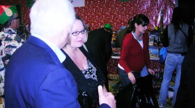 Melissa Visage gets help from Mike Caruso in selecting gifts for her two children at the 24th annual SuperParent Shopping Day in San Diego, California on Dec. 15, 2010.
