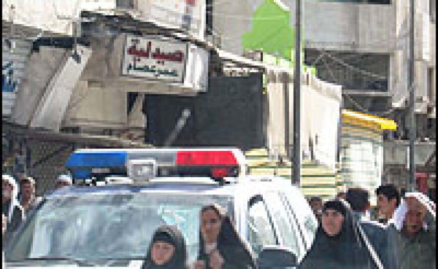 Iraqis shop under heavy police presence in Mosul.