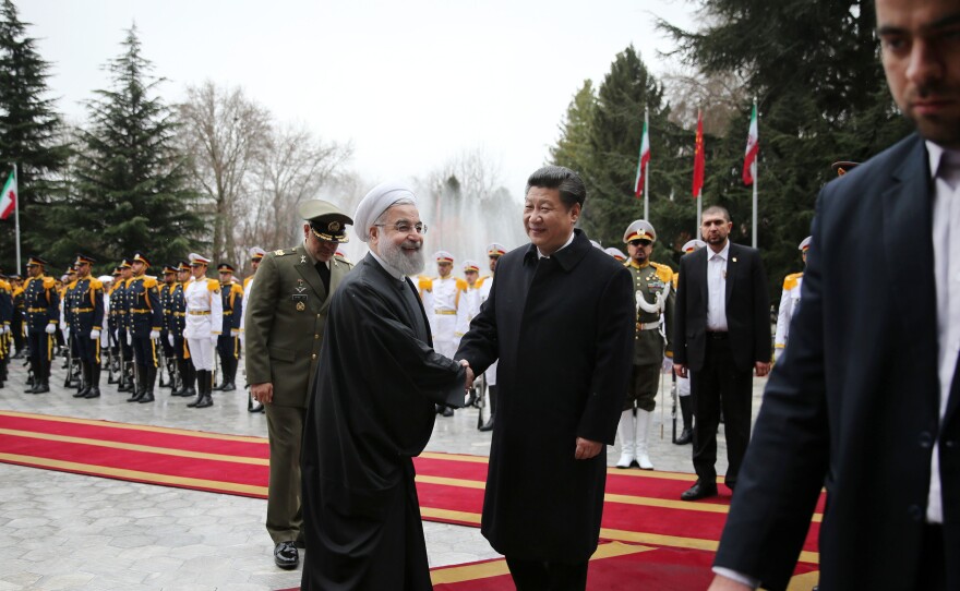 Iranian President Hassan Rouhani greets visiting Chinese President Xi Jinping at the Saadabad Palace in Tehran on Saturday. With sanctions lifted, the countries pledged to develop economic ties.